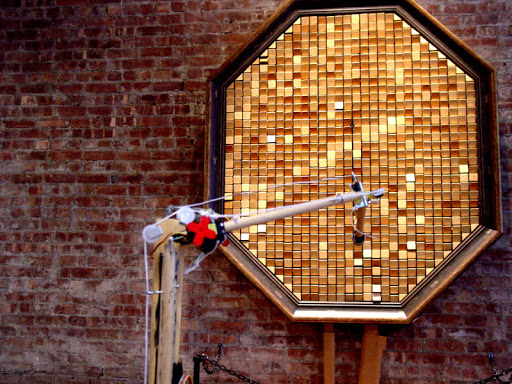 The arm transforms Danny Rozin's WOODEN MIRROR into a   self-animating piece.
