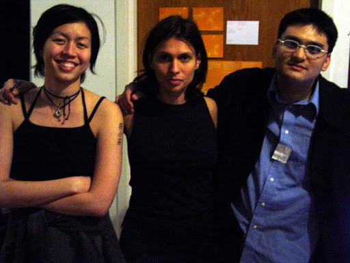 a photo taken at the ITP Spring 2003 Show, beside a   television displaying the news broadcast and a kiosk showing the website. From left to right: Ann, Kat, Josh.